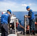 USS Sioux City Sailors and Coast Guardsmen Bring the Harbor Pilot Aboard as the Ship Pulls Into Port at Naval Station Guantanamo Bay, Cuba