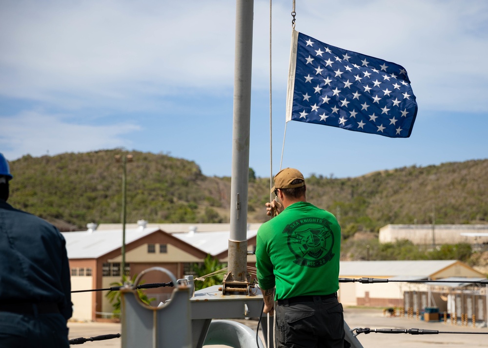 HSC 22 Sailor Raises the Union Jack as USS Sioux City Pulls Into Port at Naval Station Guantanamo Bay, Cuba