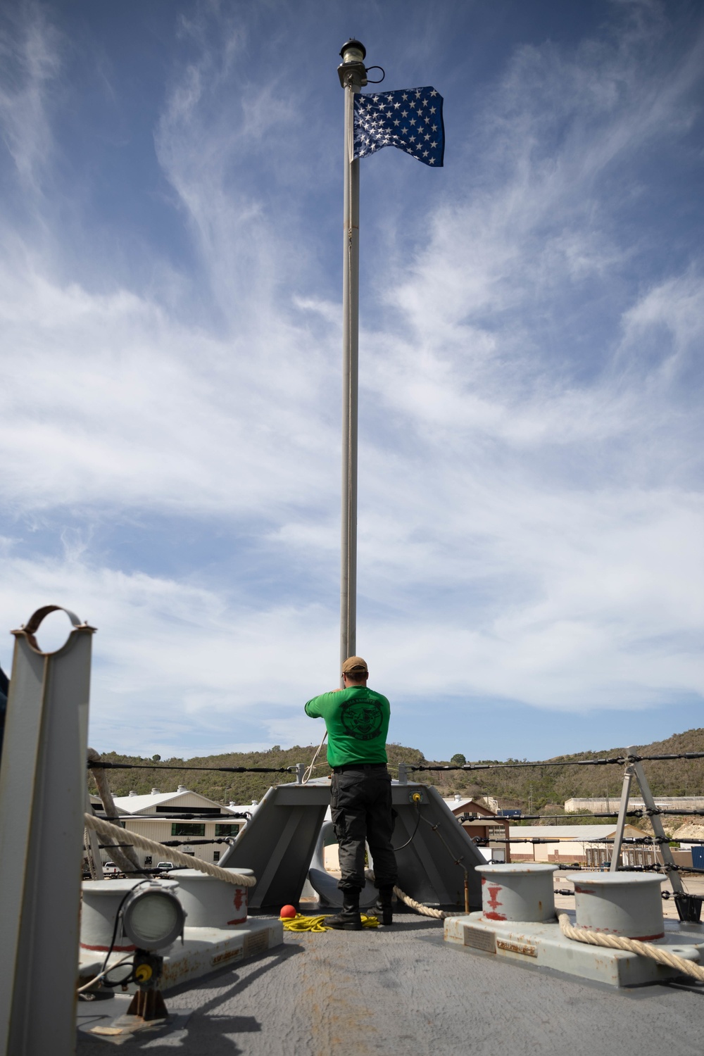 HSC 22 Sailor Raises the Union Jack as USS Sioux City Pulls Into Port at Naval Station Guantanamo Bay, Cuba