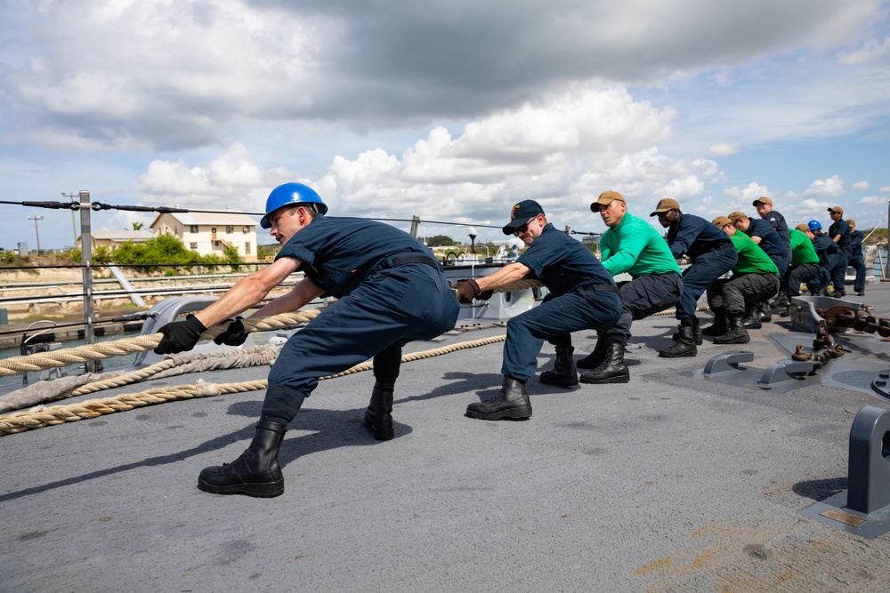 USS Sioux City and HSC 22 Sailors Handle Lines as the Ship Moors Into Port at Naval Station Guantanamo Bay, Cuba
