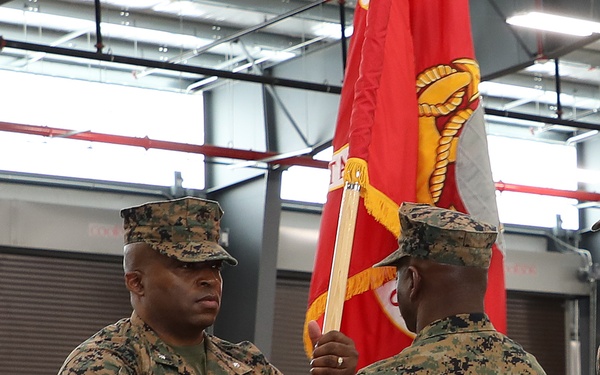 Lt. Col. Kurtis Sargent, left, incoming commanding officer, 2d Force Storage Battalion, Marine Force Storage Command, accepts 2d MFSB’s colors from Lt. Col. Fred Glencamp, outgoing CO, 2d FSB