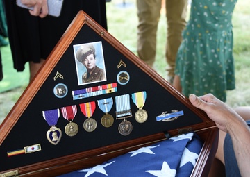 Famly members view U.S. Flag and decorations of Cpl. Eldert J. Beek