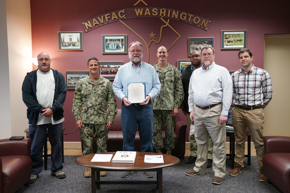 Bryan R. Dewey is honored by NAVFAC Washington teammates during his retirement ceremony on the Washington Navy Yard