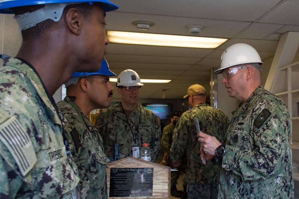 U.S. Navy Master Chief Chris Chelberg, right, commander, Naval Air Force Atlantic’s force master chief, enters the quarterdeck of the floating accommodation facility attached to the aircraft carrier USS John C. Stennis (CVN 74)