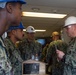 U.S. Navy Master Chief Chris Chelberg, right, commander, Naval Air Force Atlantic’s force master chief, enters the quarterdeck of the floating accommodation facility attached to the aircraft carrier USS John C. Stennis (CVN 74)