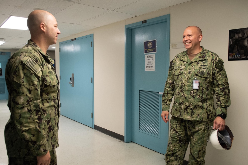 U.S. Navy Master Chief Petty Officer Chris Chelberg, right, commander, Naval Air Force Atlantic’s force master chief, speaks to a sailor assigned to the aircraft carrier USS John C. Stennis (CVN 74) about the ship’s Refueling and Complex Overhaul,