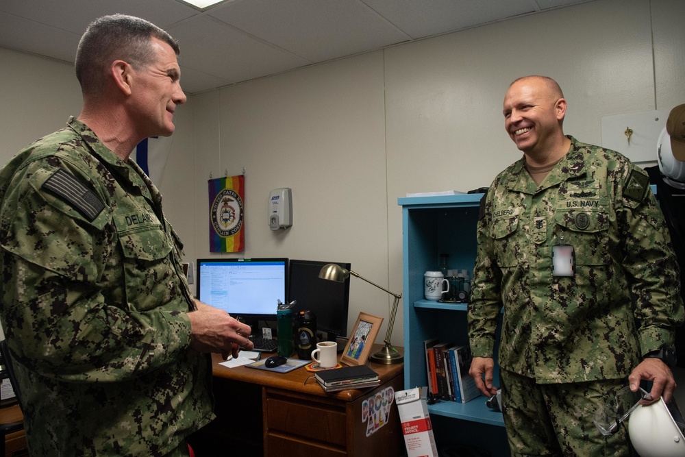 U.S. Navy Master Chief Petty Officer Chris Chelberg, force master chief speaks to Lt. Cmdr. Conrad Delaney, deputy chaplain, assigned to the aircraft carrier USS John C. Stennis (CVN 74) about the ship’s Refueling and Complex Overhaul.