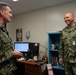 U.S. Navy Master Chief Petty Officer Chris Chelberg, force master chief speaks to Lt. Cmdr. Conrad Delaney, deputy chaplain, assigned to the aircraft carrier USS John C. Stennis (CVN 74) about the ship’s Refueling and Complex Overhaul.