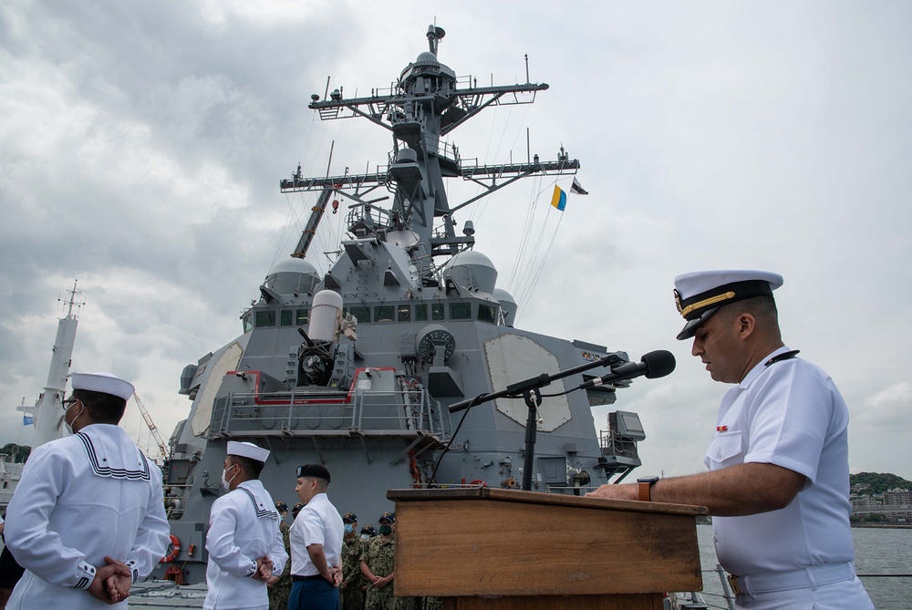 Two Sailors and one Soldier become new citizens of the U.S. during a naturalization ceremony aboard USS Milius stationed at CFAY