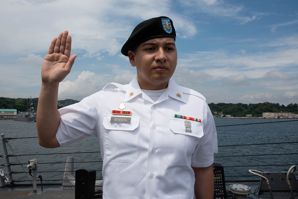 Two Sailors and one Soldier become new citizens of the U.S. during a naturalization ceremony aboard USS Milius stationed at CFAY