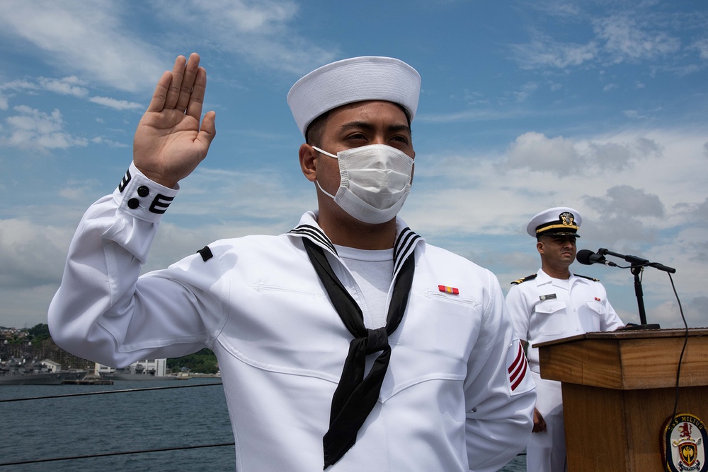 Two Sailors and one Soldier become new citizens of the U.S. during a naturalization ceremony aboard USS Milius stationed at CFAY