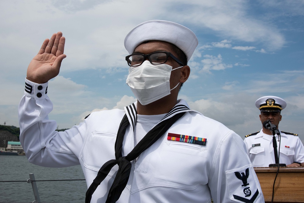Two Sailors and one Soldier become new citizens of the U.S. during a naturalization ceremony aboard USS Milius stationed at CFAY