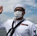 Two Sailors and one Soldier become new citizens of the U.S. during a naturalization ceremony aboard USS Milius stationed at CFAY