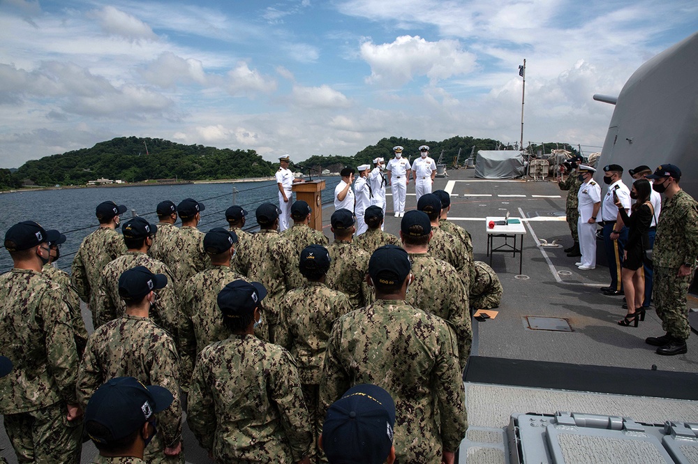 Two Sailors and one Soldier become new citizens of the U.S. during a naturalization ceremony aboard USS Milius stationed at CFAY