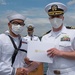 Two Sailors and one Soldier become new citizens of the U.S. during a naturalization ceremony aboard USS Milius stationed at CFAY