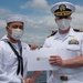 Two Sailors and one Soldier become new citizens of the U.S. during a naturalization ceremony aboard USS Milius stationed at CFAY