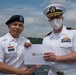 Two Sailors and one Soldier become new citizens of the U.S. during a naturalization ceremony aboard USS Milius stationed at CFAY