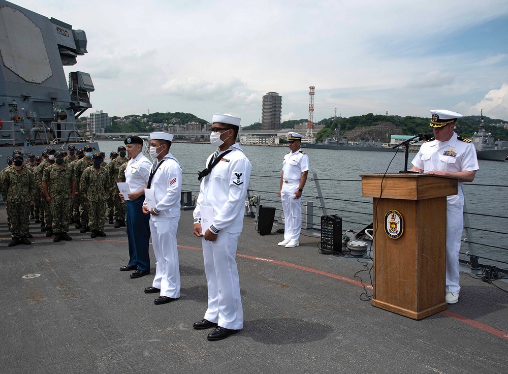 Two Sailors and one Soldier become new citizens of the U.S. during a naturalization ceremony aboard USS Milius stationed at CFAY