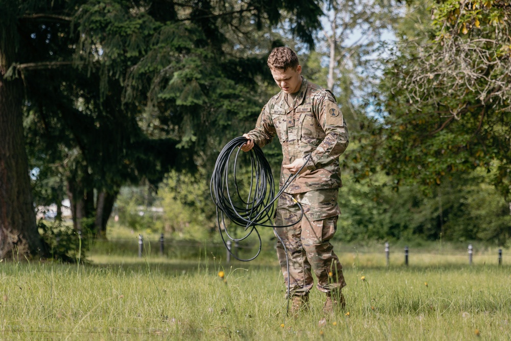 Spc. Todd Whittle prepares the training site to conduct radio retransmission.