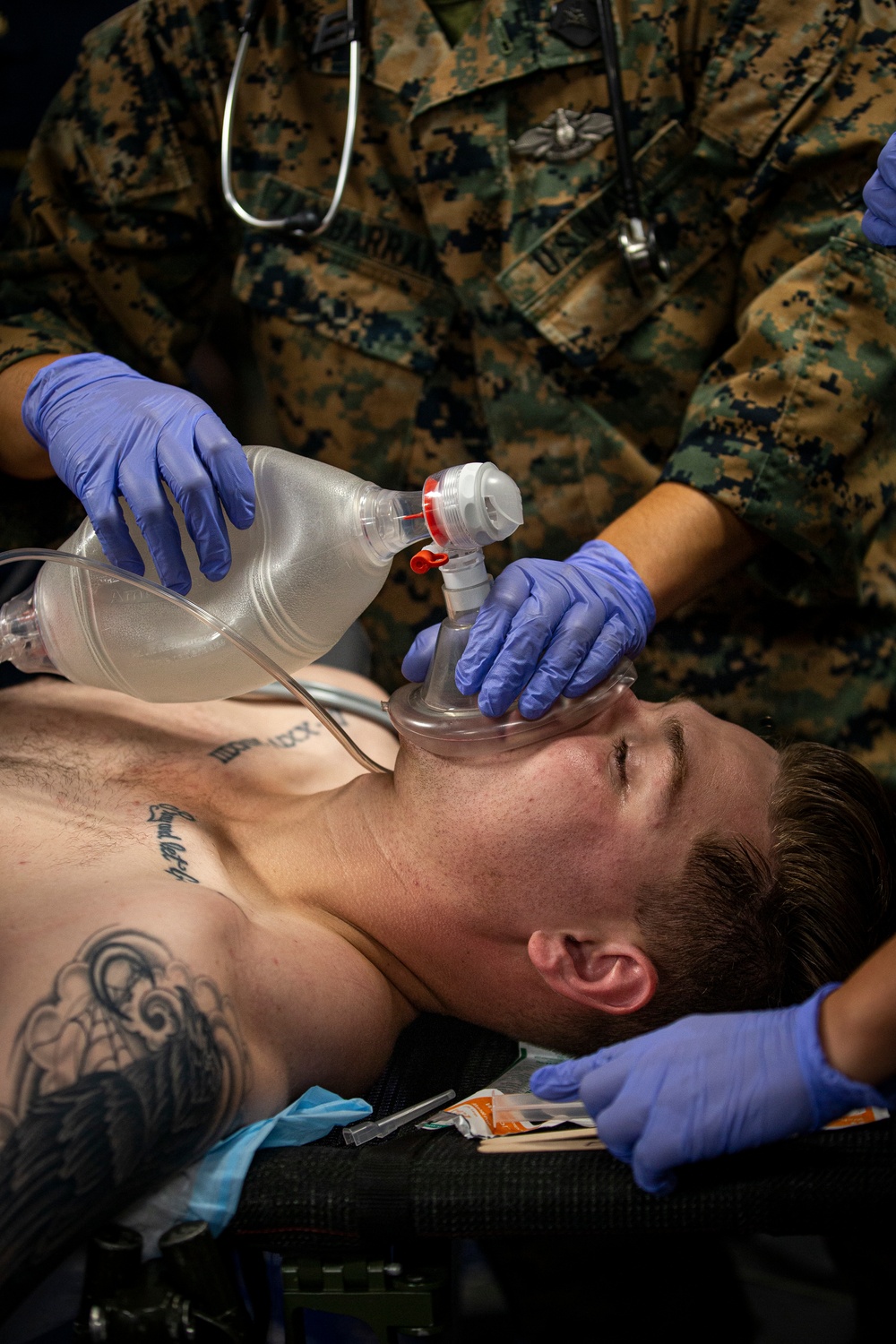 US Navy Sailors conduct a simulated mass casualty drill in response to a helicopter raid training exercise