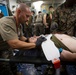 US Navy Sailors conduct a simulated mass casualty drill in response to a helicopter raid training exercise