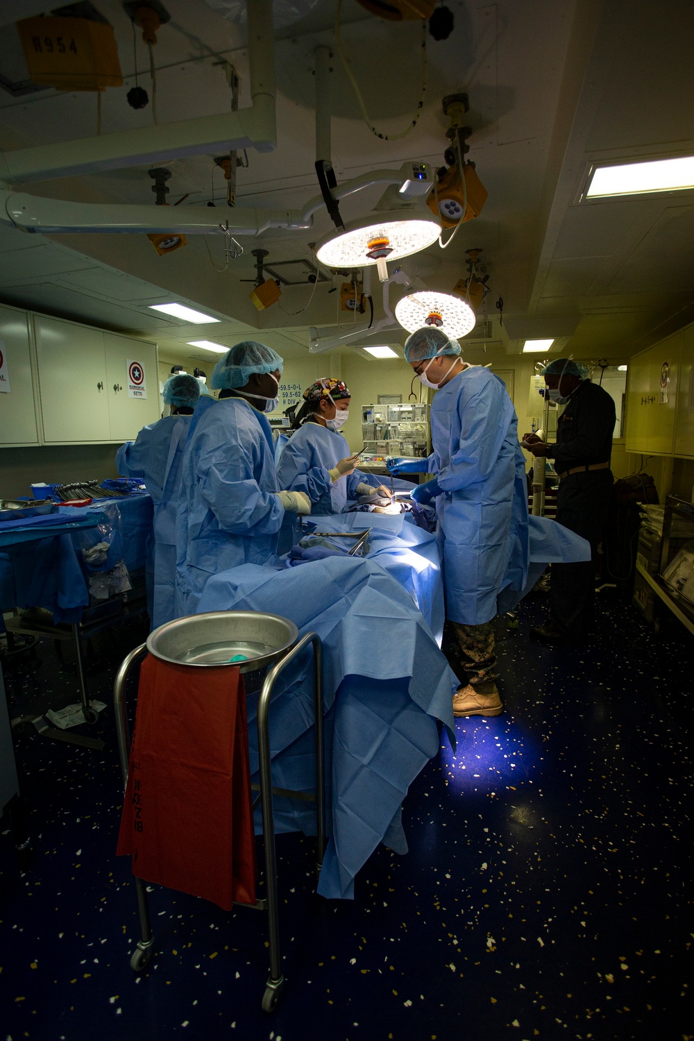 US Navy Sailors conduct a simulated mass casualty drill in response to a helicopter raid training exercise