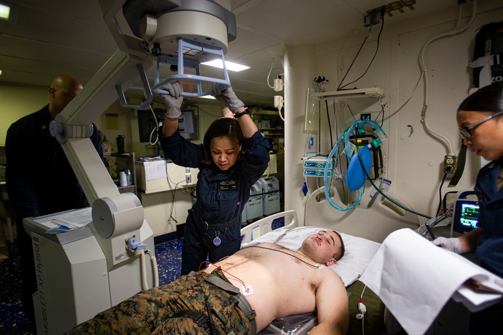 US Navy Sailors conduct a simulated mass casualty drill in response to a helicopter raid training exercise