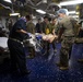 US Navy Sailors conduct a simulated mass casualty drill in response to a helicopter raid training exercise