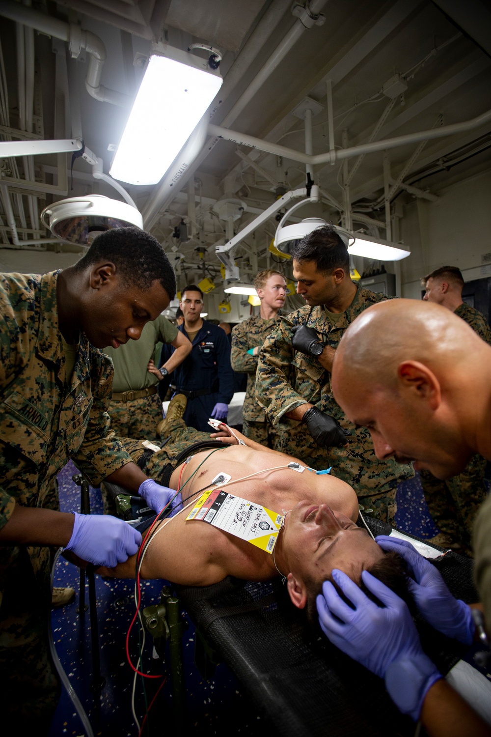 US Navy Sailors conduct a simulated mass casualty drill in response to a helicopter raid training exercise