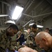 US Navy Sailors conduct a simulated mass casualty drill in response to a helicopter raid training exercise