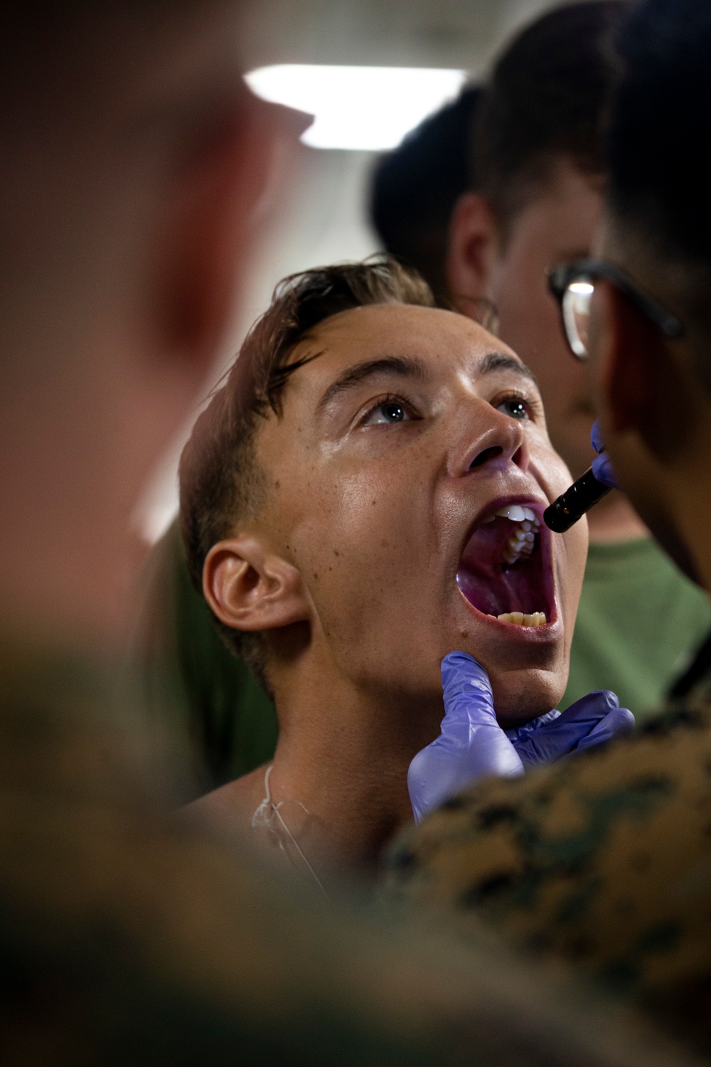 US Navy Sailors conduct a simulated mass casualty drill in response to a helicopter raid training exercise