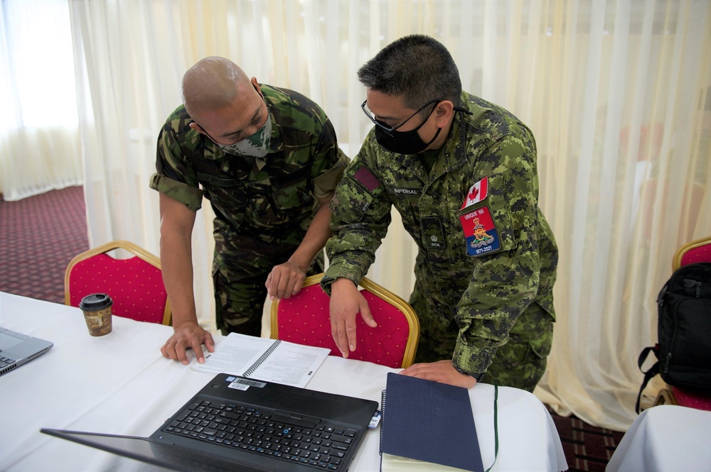Canadian Armed Forces members providing operations planning process mentorship