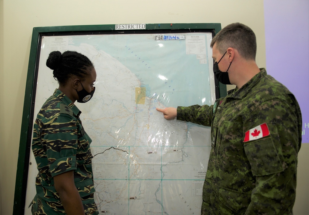 Canadian Armed Forces members providing operations planning process mentorship