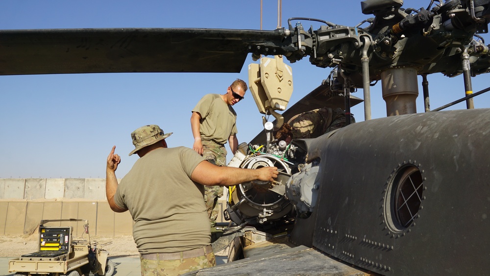 Soldiers working to remove T700 engine from a Black Hawk helicopter