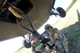 Student performs delicate task under shadow of 6-ton, hovering aircraft