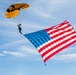 Parachutist on Army Golden Knights makes jump with flag banner