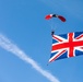 Parachutist makes jump with British flag banner