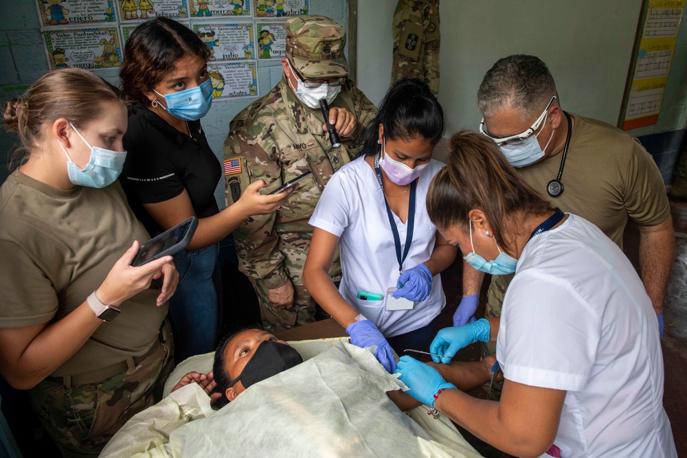 U.S. military medical professionals provide emergency care during RS-21