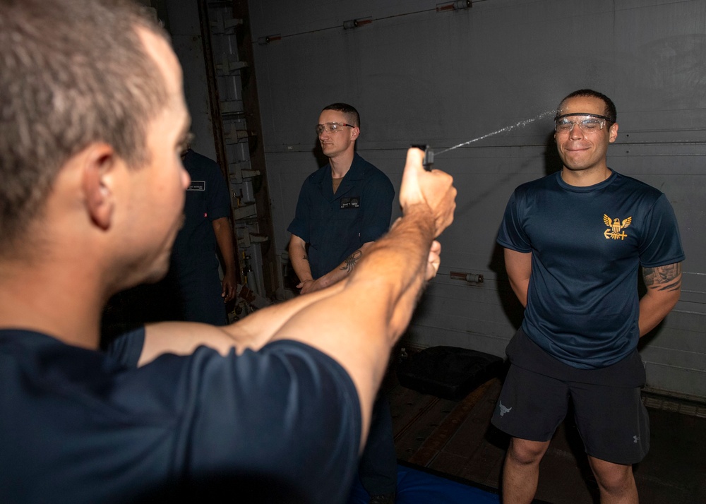 Sailors are sprayed with Oleoresin Capsaicin (OC) during security training