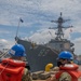 Sailors Watch USS Mustin Depart