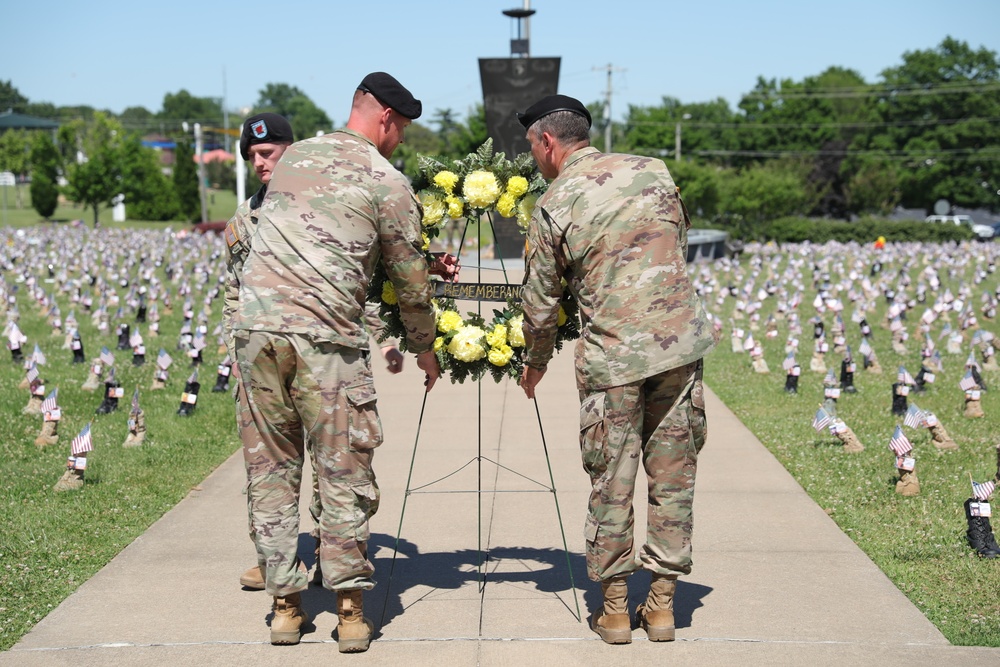 Maj. Gen. McGee and Sgt. Maj. Buda lifts the Memorial Wreath.