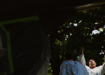 Airmen conduct maintenance on historical aircraft displays