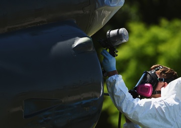 Airmen conduct maintenance on historical aircraft displays