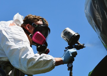 Airmen conduct maintenance on historical aircraft displays