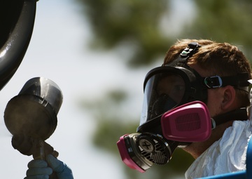 Airmen conduct maintenance on historical aircraft displays