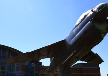 Airmen conduct maintenance on historical aircraft displays