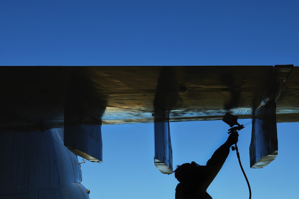 Airmen conduct maintenance on historical aircraft displays