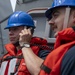 Information Systems Technician 2nd Class Isaak Mejia (left), from Los Angeles, Calif., communicates with the pilot house