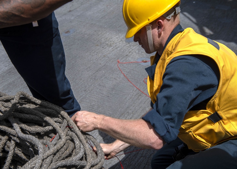 Boatswain’s Mate Seaman Graden Beasley, from San Diego, Calif., secures a pallet of line