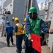Seaman Jonathan Taylor, from Killeen, Texas, signals to detach the highline during a replenishment-at-sea